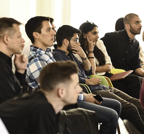 Some people sitting in a chair's and listening to seminar